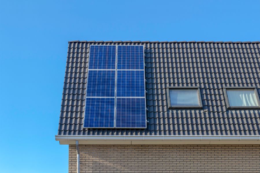 Tiled house roof with solar panels